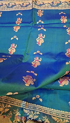 Blue green dual tone figure motif with heeran motif on the border with meena Baluchari saree Blue green dual tone figure motif with heeran motif on the border with meena Baluchari saree