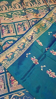 Blue green dual tone figure motif with heeran motif on the border with meena Baluchari saree Blue green dual tone figure motif with heeran motif on the border with meena Baluchari saree