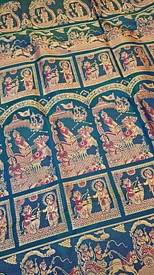 Blue green dual tone figure motif with heeran motif on the border with meena Baluchari saree Blue green dual tone figure motif with heeran motif on the border with meena Baluchari saree